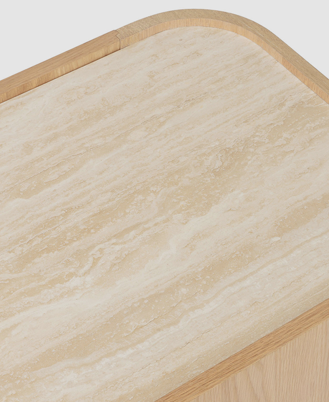 A top-down shot of the top of the TV unit highlights the warm, creamy grains of the travertine surface. A top-down shot of the top of the TV unit highlights the warm, creamy grains of the travertine surface.