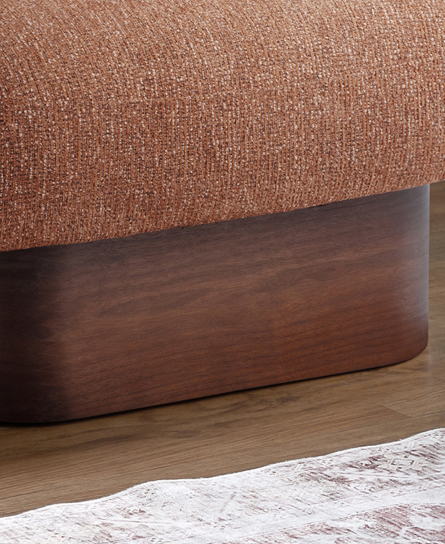The rich walnut armchair platform base supports a burnt orange seat.