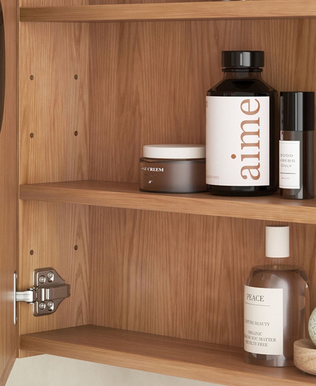 The cabinet door is open to reveal two shelves that are filled with grooming products. The cabinet door is open to reveal two shelves that are filled with grooming products.