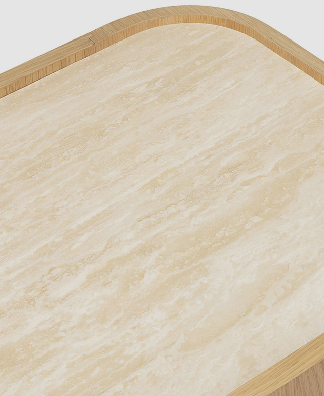 A top-down shot of the top of the sideboard highlights the warm, creamy grains of the travertine surface. A top-down shot of the top of the sideboard highlights the warm, creamy grains of the travertine surface.