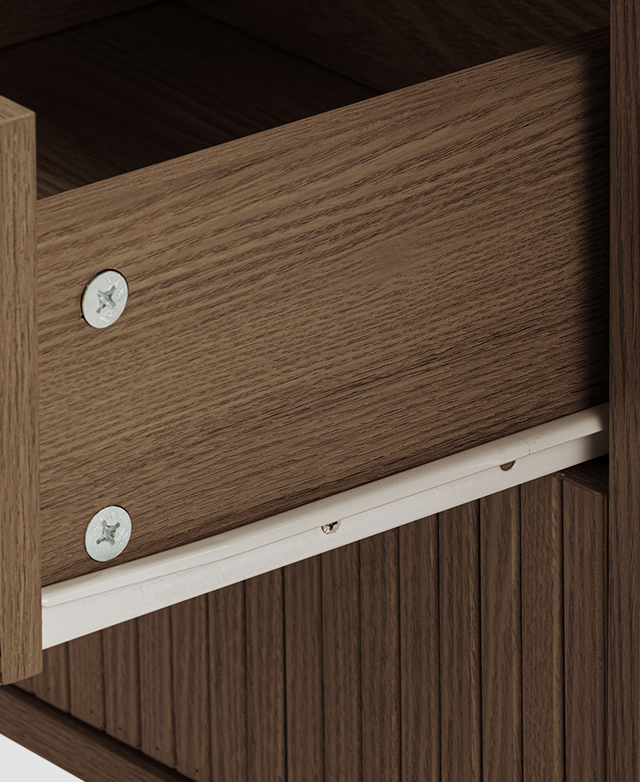 A close-up of the side of a walnut drawer highlights the strong metal runner.