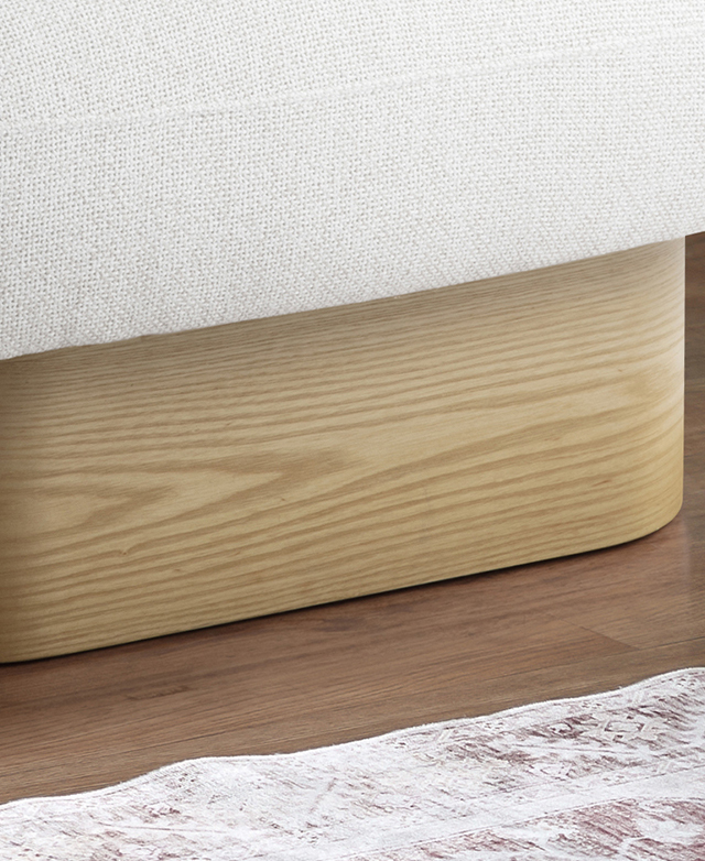 The golden oak wood armchair platform base supports an off-white coloured seat.
