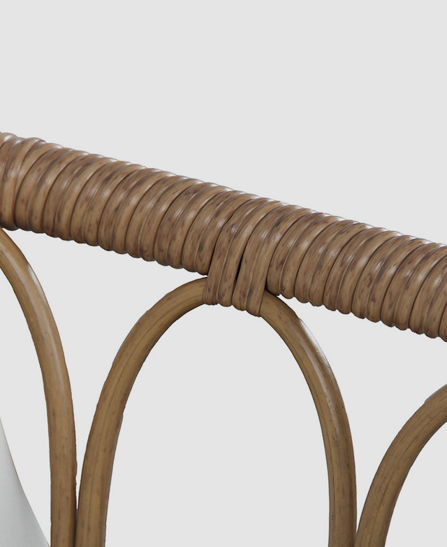 Polyurethane rattan is wrapped around the chairs arms and shown up close. Polyurethane rattan is wrapped around the chairs arms and shown up close.