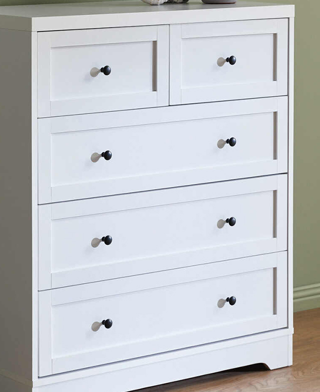 Three-quarter angle emphasises the chest's shaker-style drawers and small metal knobs.