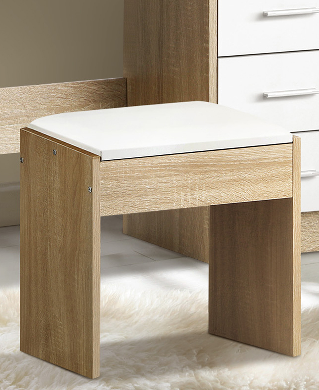 The blocky stool design has a white seat that's upholstered with white faux leather.