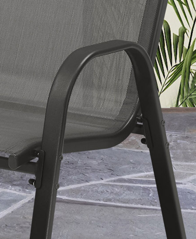 A rounded, U-shaped black metal armrest-cum-leg structure is in focus. A rounded, U-shaped black metal armrest-cum-leg structure is in focus.
