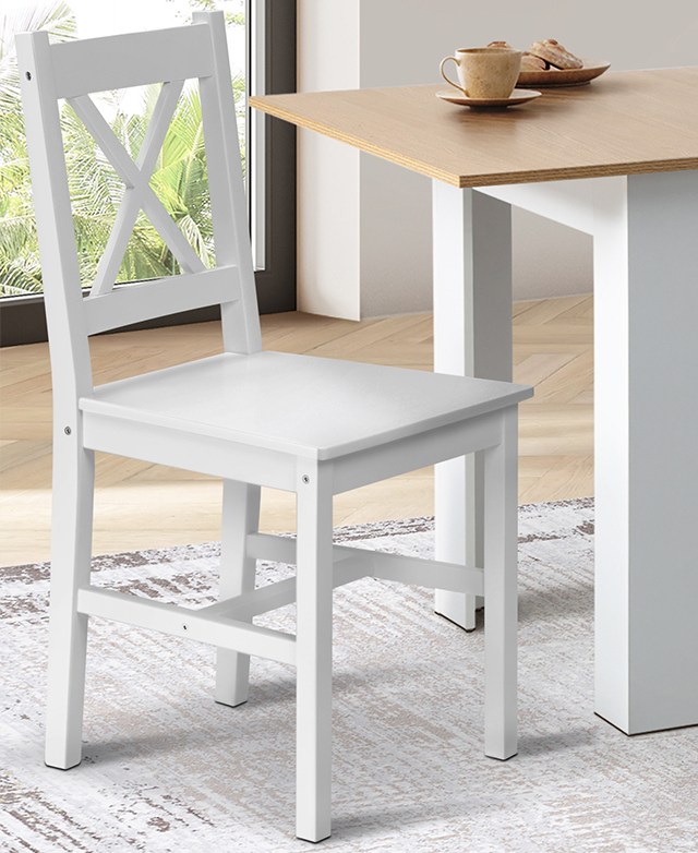 The full dining chair is at an angle next to a white and honey-coloured dining table, on top of an abstract grey rug. The full dining chair is at an angle next to a white and honey-coloured dining table, on top of an abstract grey rug.