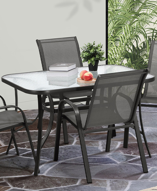 The full rectangular glass-top table is shown with four coordinating black-framed armchairs around it. The full rectangular glass-top table is shown with four coordinating black-framed armchairs around it.