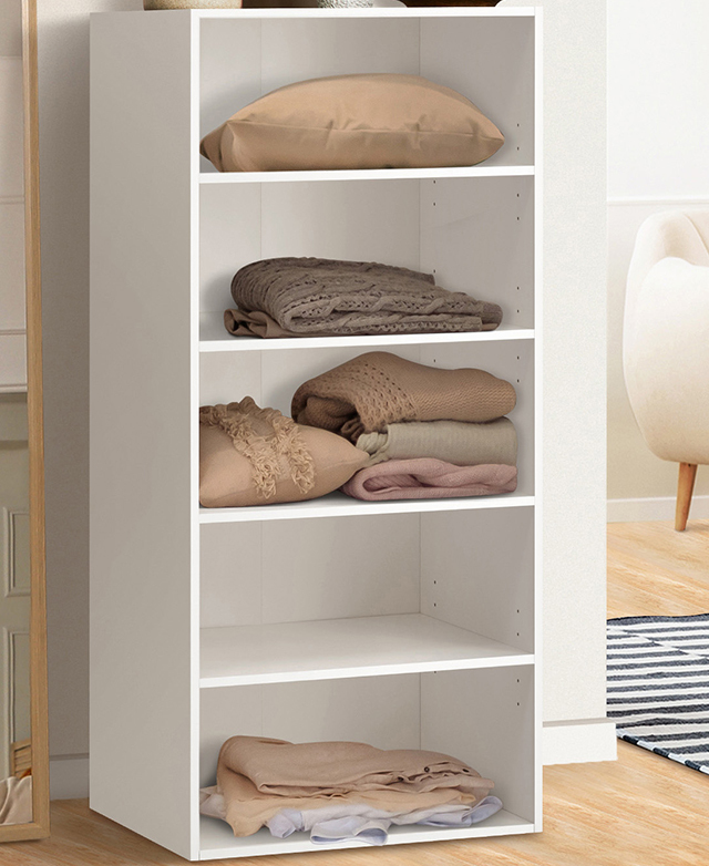 The full shelf wardrobe is shown with textiles folded on four out of five shelves. The full shelf wardrobe is shown with textiles folded on four out of five shelves.