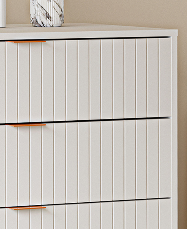 Fluting on the front of the drawers are geometric and contemporary, while contrasting tab handles stand out. Fluting on the front of the drawers are geometric and contemporary, while contrasting tab handles stand out.