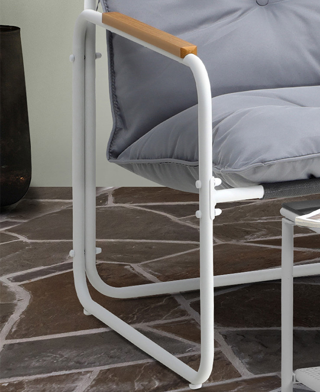 The slender tube frame of the white seat highlights the minimalist style and the airy negative space.