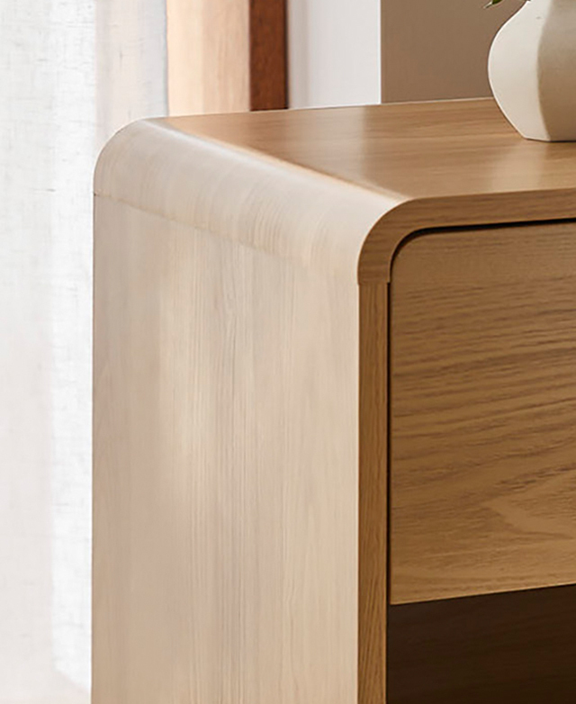 A rounded top edge shows the seamless flow of the side table's frame. A rounded top edge shows the seamless flow of the side table's frame.