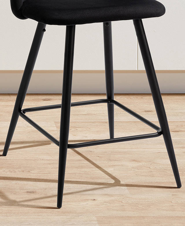 Tapered black metal legs and their reinforcing leg brace on a timber floor. Tapered black metal legs and their reinforcing leg brace on a timber floor.