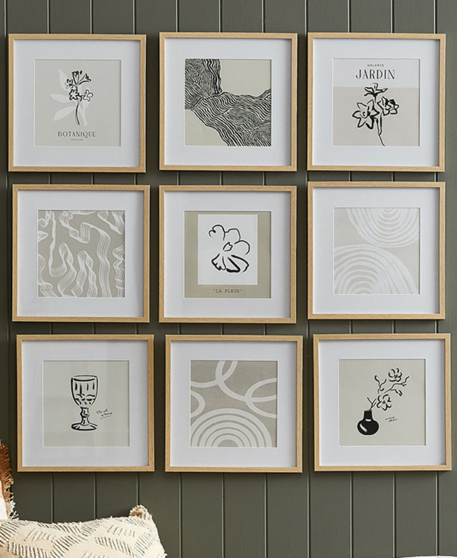 Nine 'natural' frames feature abstract and floral images, all hung in a grid on an olive panelled wall. Nine 'natural' frames feature abstract and floral images, all hung in a grid on an olive panelled wall.