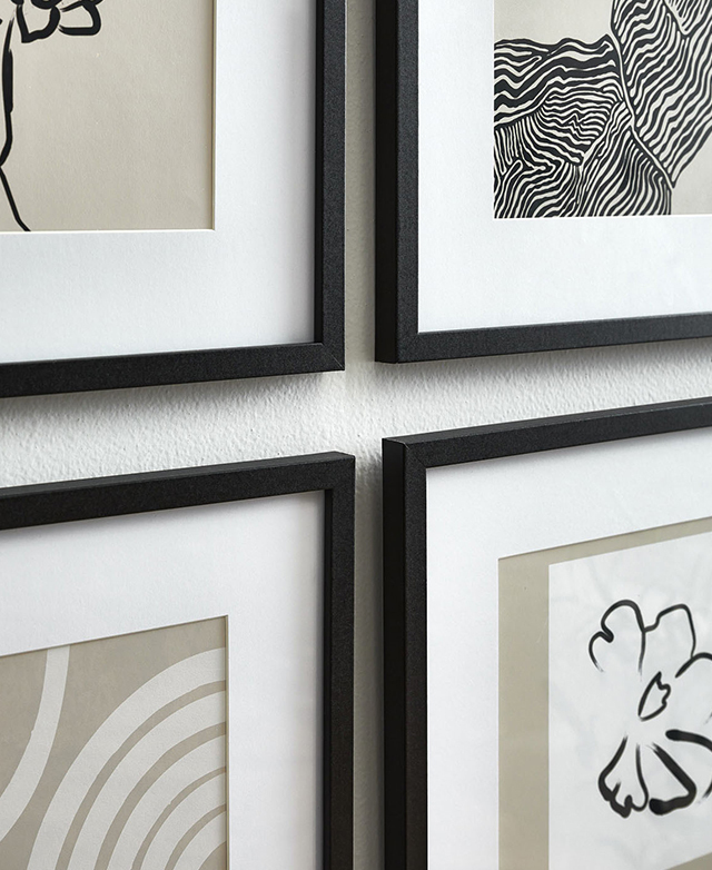 Four corners of four slender black frames are zoomed in on. Four corners of four slender black frames are zoomed in on.