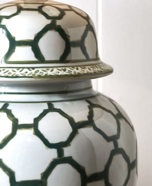 A close-up of the green and white ceramic lamp base shows off its polished finish. A close-up of the green and white ceramic lamp base shows off its polished finish.