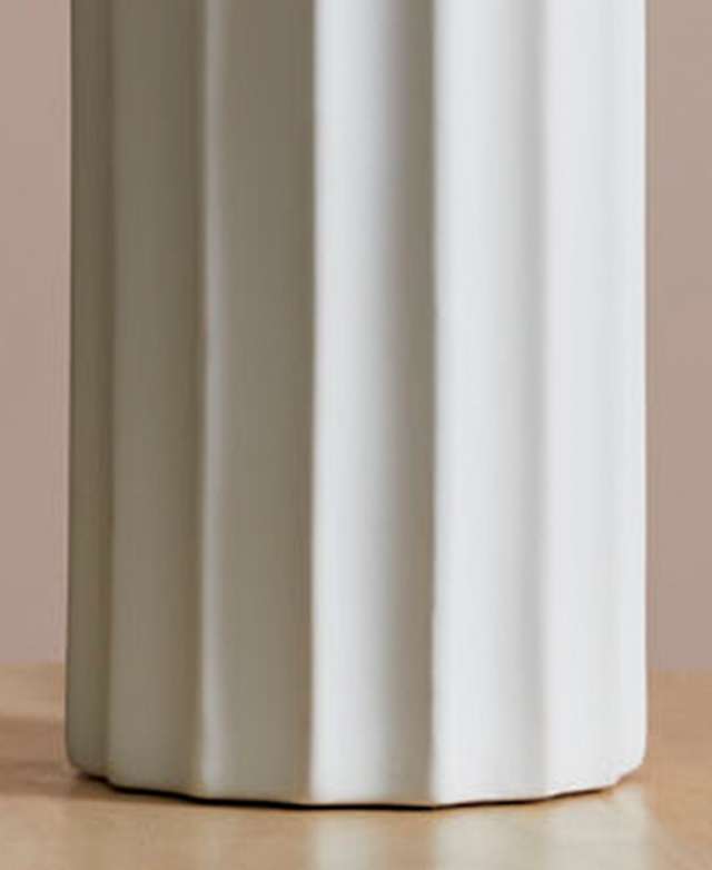 A close-up view of the white lamp base highlights its texture. A close-up view of the white lamp base highlights its texture.