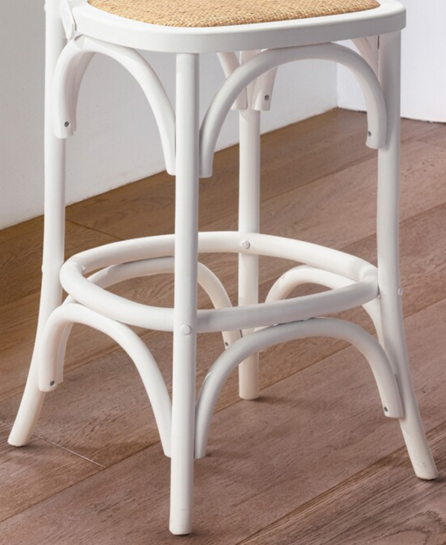 The base of a white bar stool features several bentwood features that serve as extra reinforcement.
