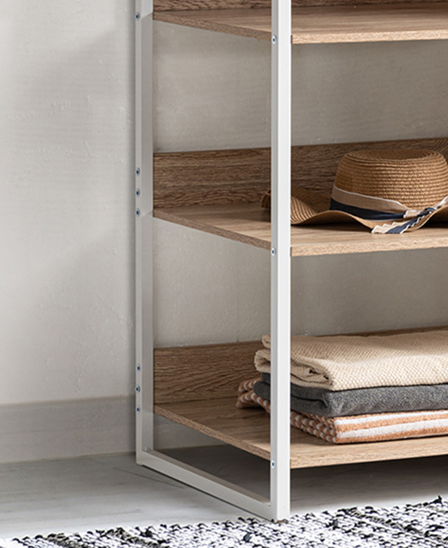A cropped view of the open side of the wardrobe shows the white, metal frame, with neatly arranged items on the shelves. A cropped view of the open side of the wardrobe shows the white, metal frame, with neatly arranged items on the shelves.