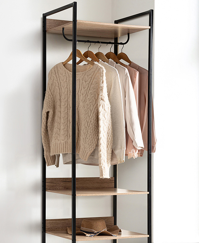 The top portion of the black open-framed wardrobe features hung clothing in a bright room. The top portion of the black open-framed wardrobe features hung clothing in a bright room.