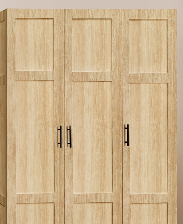 Shaker-style cupboard doors of the light timber cupboard are in focus, with sleek black bar handles shown. Shaker-style cupboard doors of the light timber cupboard are in focus, with sleek black bar handles shown.