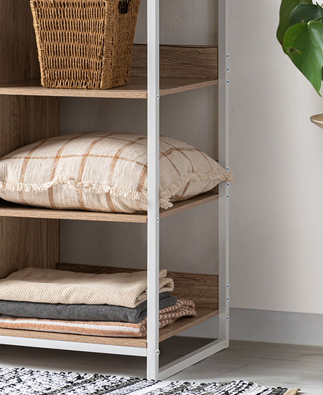 A cropped view of the open side of the wardrobe shows the white, metal frame, with neatly arranged items on the shelves. A cropped view of the open side of the wardrobe shows the white, metal frame, with neatly arranged items on the shelves.