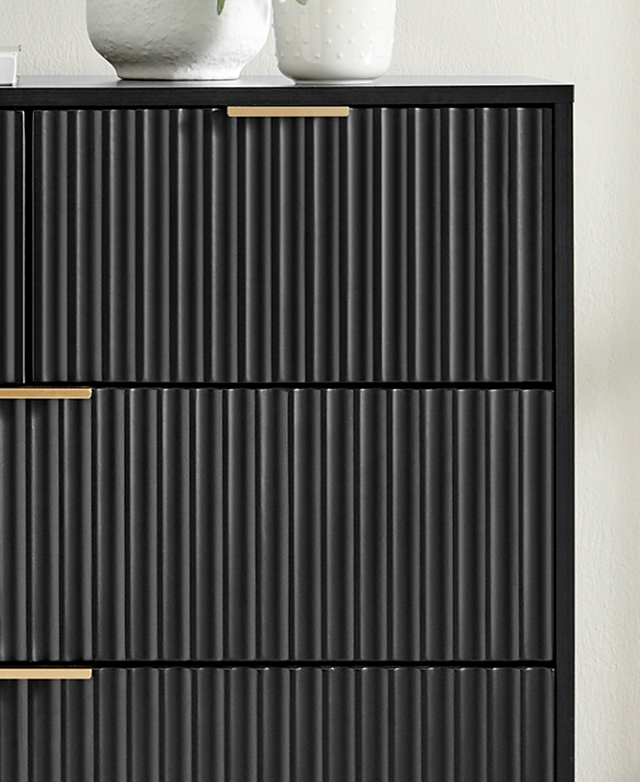 The top-front corner of the chest features textured fluting and beautiful brass tab handles for the drawers. The top-front corner of the chest features textured fluting and beautiful brass tab handles for the drawers.