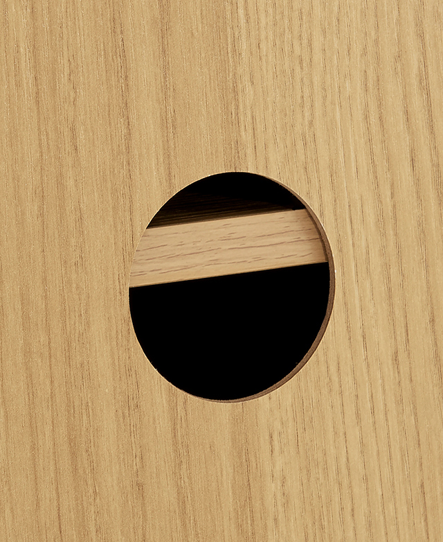 Cable hole in the back panel of the light timber entertainment unit.