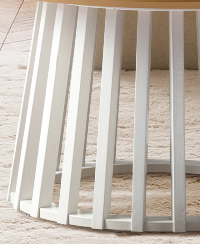 The white, vertical slats and negative space between them demonstrate the coffee table's airy design.