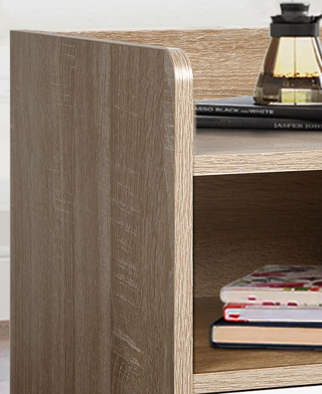 A close-up of the natural bedside table to show its rounded side panel-cum leg; books are on the shelves.