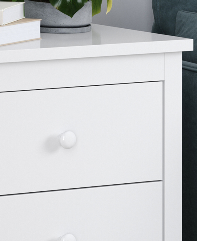 Close up of the white side table's surfaces show the polished melamine finish. Close up of the white side table's surfaces show the polished melamine finish.