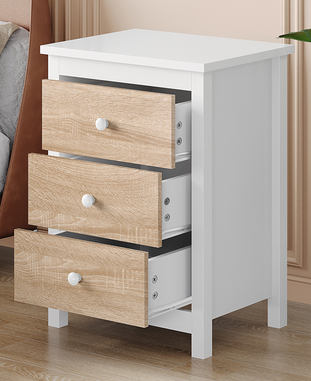 Side table shown at an angle with all three natural-coloured drawers slightly open. Side table shown at an angle with all three natural-coloured drawers slightly open.