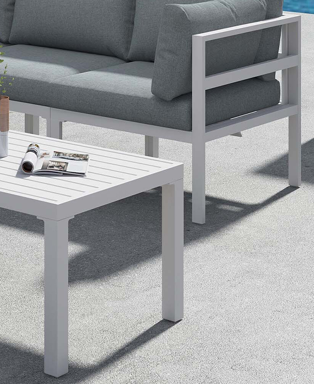 Cropped view of the white coffee table and lounge in the background show the clean lines of the metal frames.