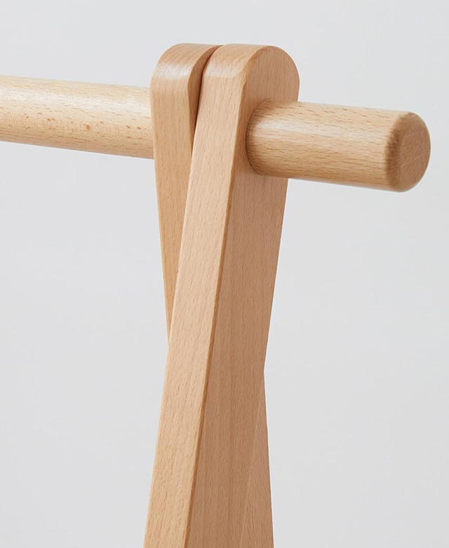 Close up of the clothing rack shows the smoothly finished frame top and dowel, all in beautiful honey-coloured beech wood.