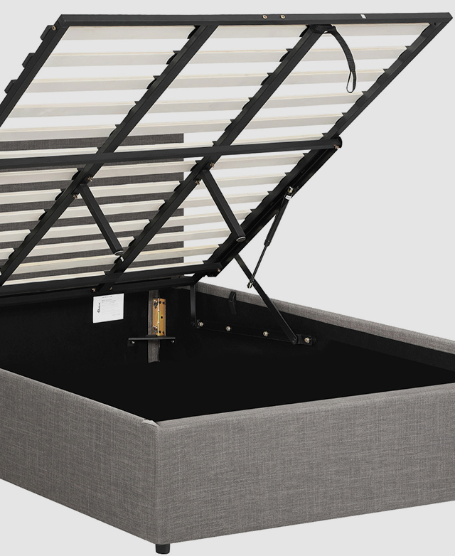 The slatted mattress support of the grey bed is elevated to reveal storage space beneath. The slatted mattress support of the grey bed is elevated to reveal storage space beneath.