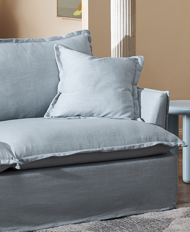 One end of the blue sofa has large, generously filled cushions, all with thick French seams. One end of the blue sofa has large, generously filled cushions, all with thick French seams.