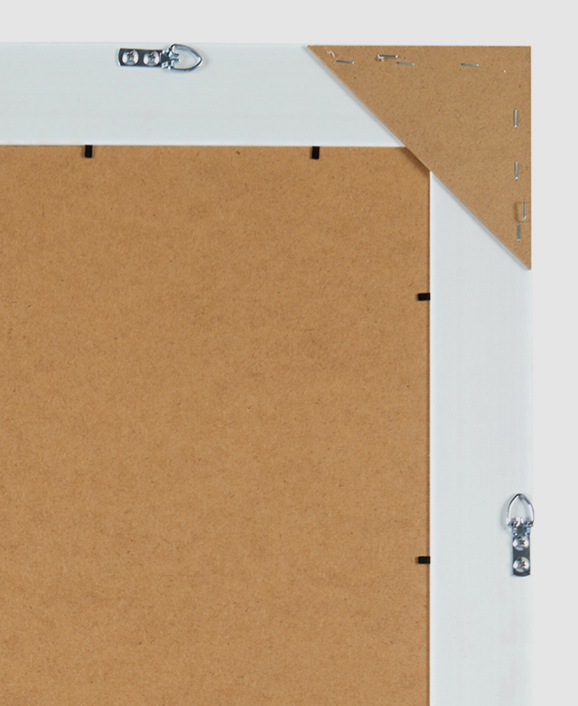A cropped view of the back of the mirror has metal hanging hooks on two sides for versatile hanging options.