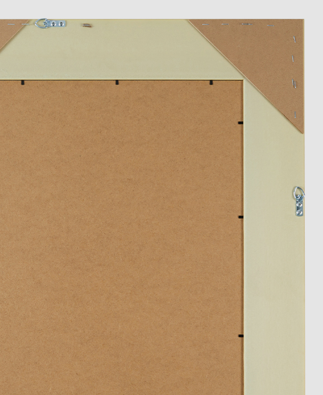 A cropped view of the back of the mirror has metal hanging hooks on two sides for versatile hanging options. A cropped view of the back of the mirror has metal hanging hooks on two sides for versatile hanging options.