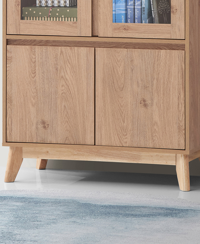 The gently splayed rubberwood legs, and the plinth, are shown beneath the cupboards of the cabinet. The gently splayed rubberwood legs, and the plinth, are shown beneath the cupboards of the cabinet.