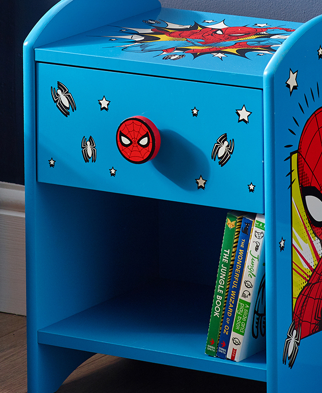 The brightly-coloured Spiderman side table is shown in full, with comic motifs adorning the surfaces. The brightly-coloured Spiderman side table is shown in full, with comic motifs adorning the surfaces.