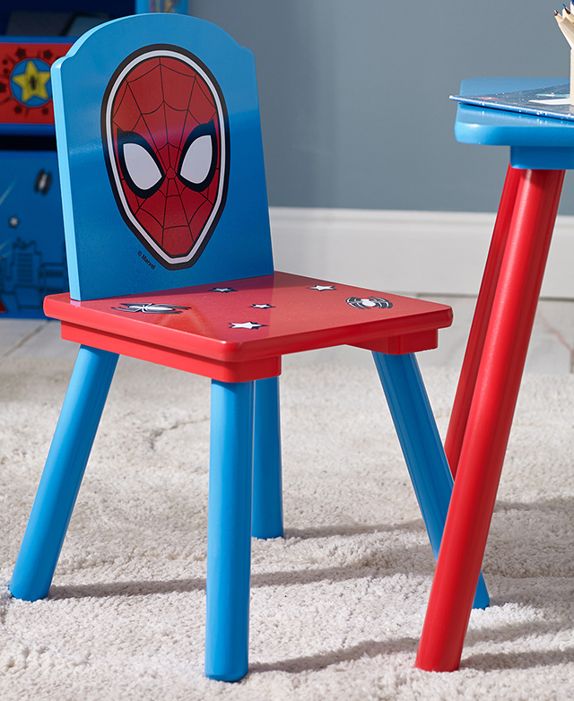 The simple, brightly-coloured chair is positioned next to the table on a cream rug.