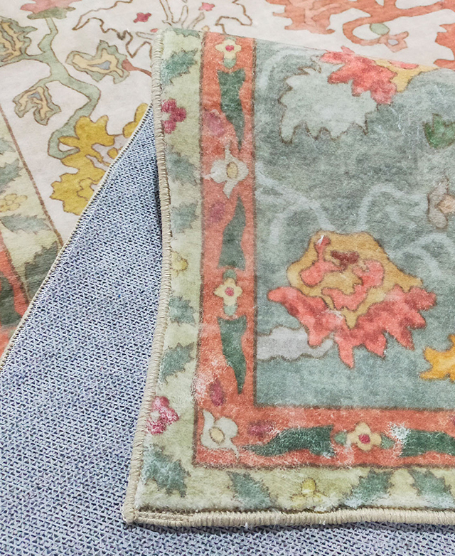 The flexible, colourful patterned rug is folded back on itself.