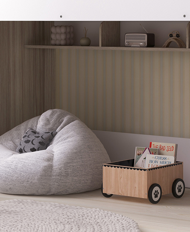 Space beneath the loft bed features a shelf filled with decor, and the floor is taken up with a beanbag and book trolley.