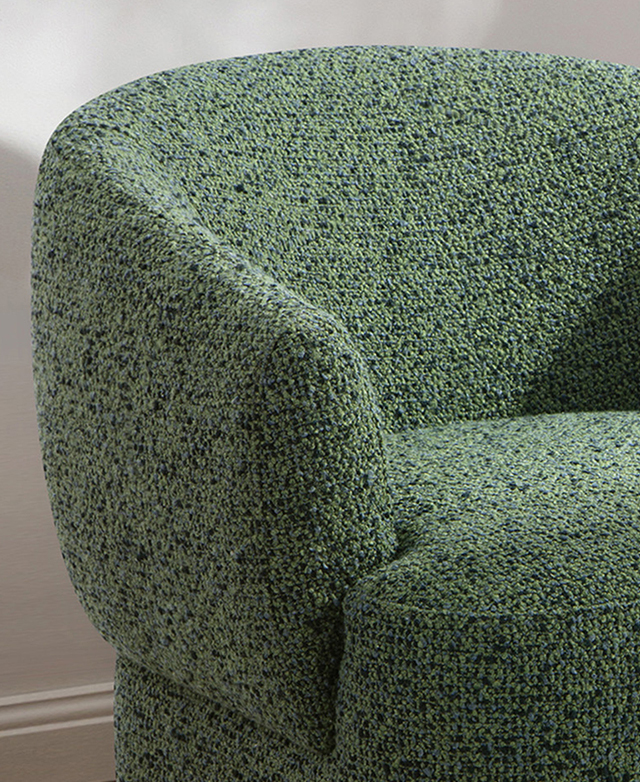 A cropped view of the green swivel armchair emphasises the sloping, curved backrest and well-filled surfaces. A cropped view of the green swivel armchair emphasises the sloping, curved backrest and well-filled surfaces.