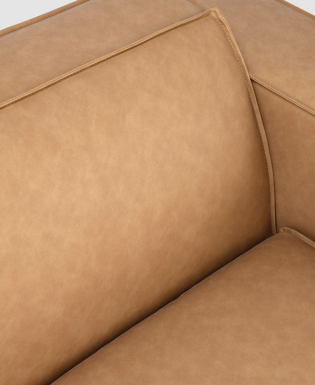 Smooth surfaces have a gently mottled finish, and the faux leather upholstery is complete with piping trims. Smooth surfaces have a gently mottled finish, and the faux leather upholstery is complete with piping trims.