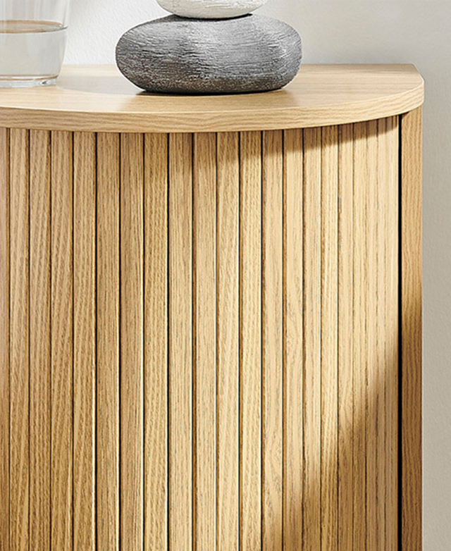 The fluted body is in the frame, highlighting the visual texture of the side table. The fluted body is in the frame, highlighting the visual texture of the side table.