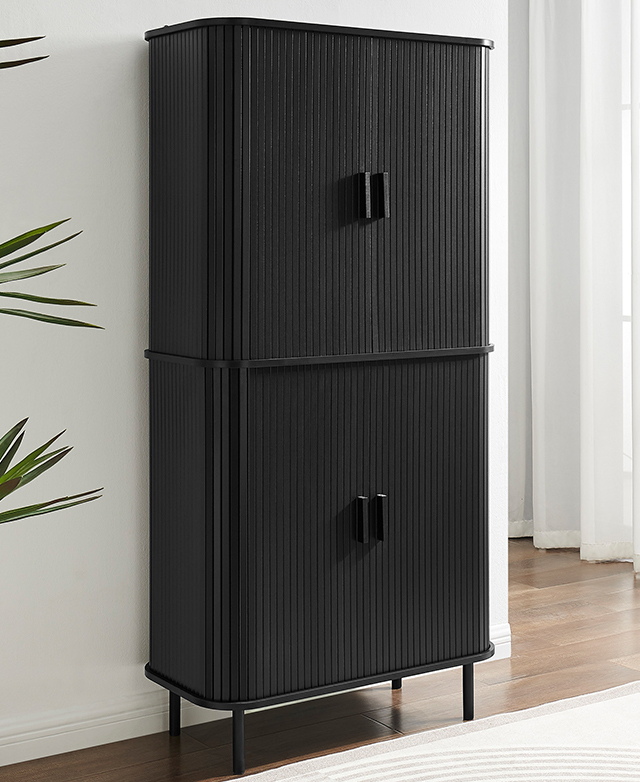The tall black fluted cabinet is pictured in a bright room on timber floor. The tall black fluted cabinet is pictured in a bright room on timber floor.