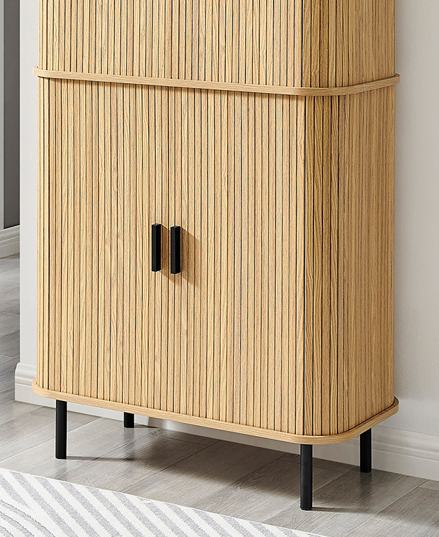 The bottom half of the oak cabinet is zoomed in on to highlight the fluting and black handles and legs. The bottom half of the oak cabinet is zoomed in on to highlight the fluting and black handles and legs.