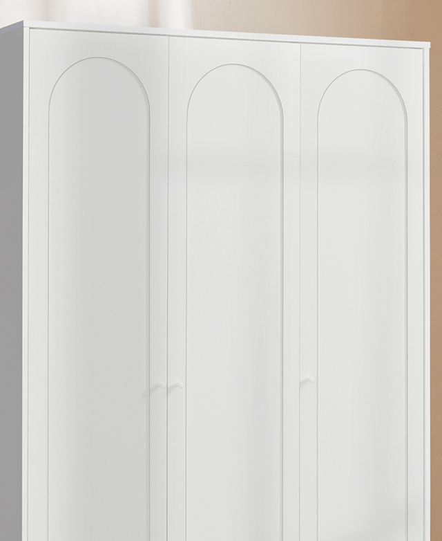 The slightly recessed arches on the front of the white cupboard's doors are in focus.