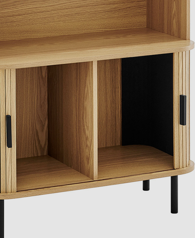 The sliding doors of the oak bookcase are open to reveal extra storage space. The sliding doors of the oak bookcase are open to reveal extra storage space.